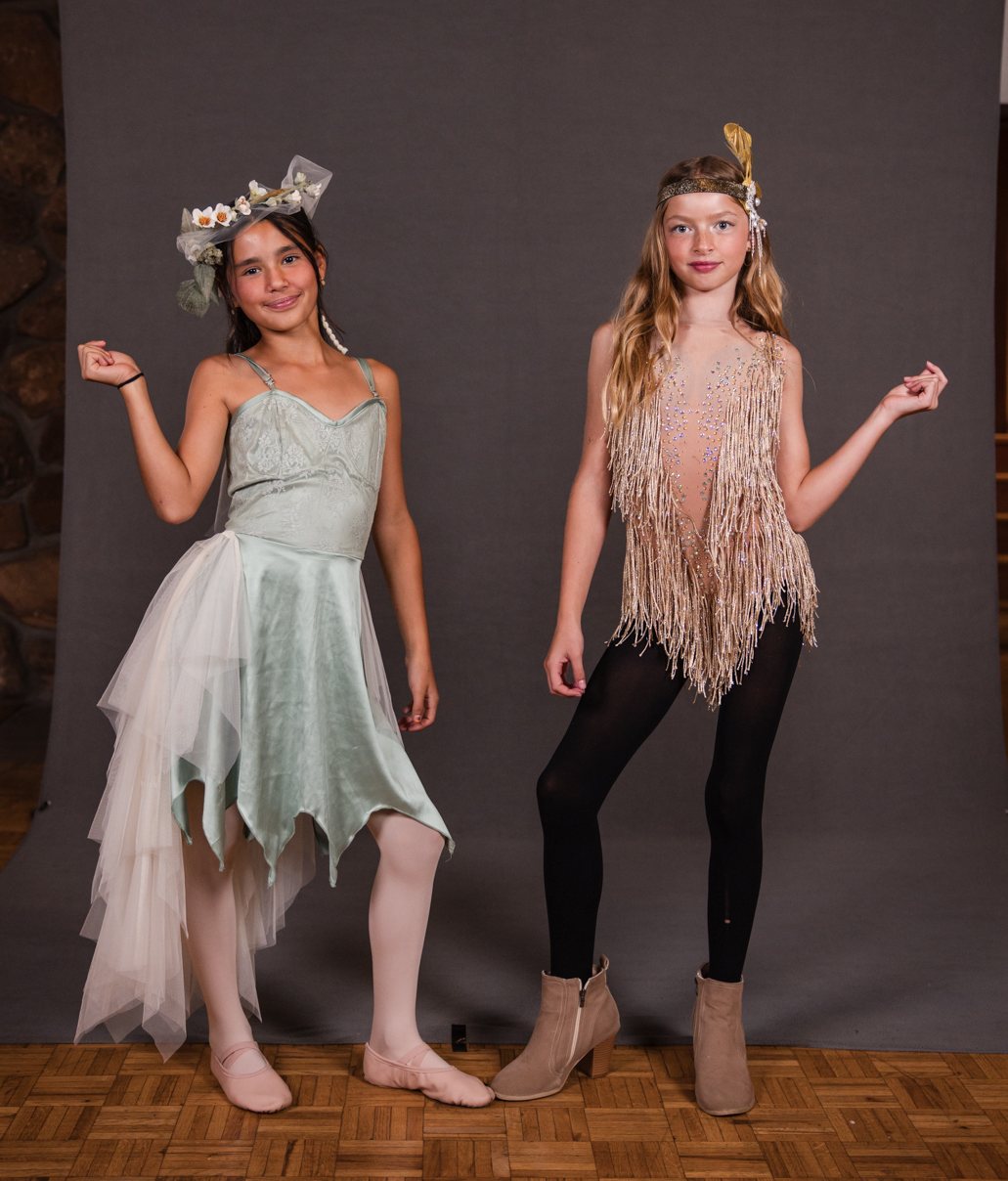 Two dancers in a mint tulle dress and a fringe top