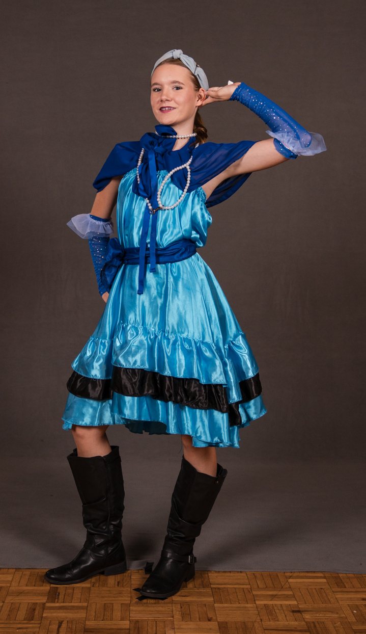 Dancer in a blue satin dress and black boots