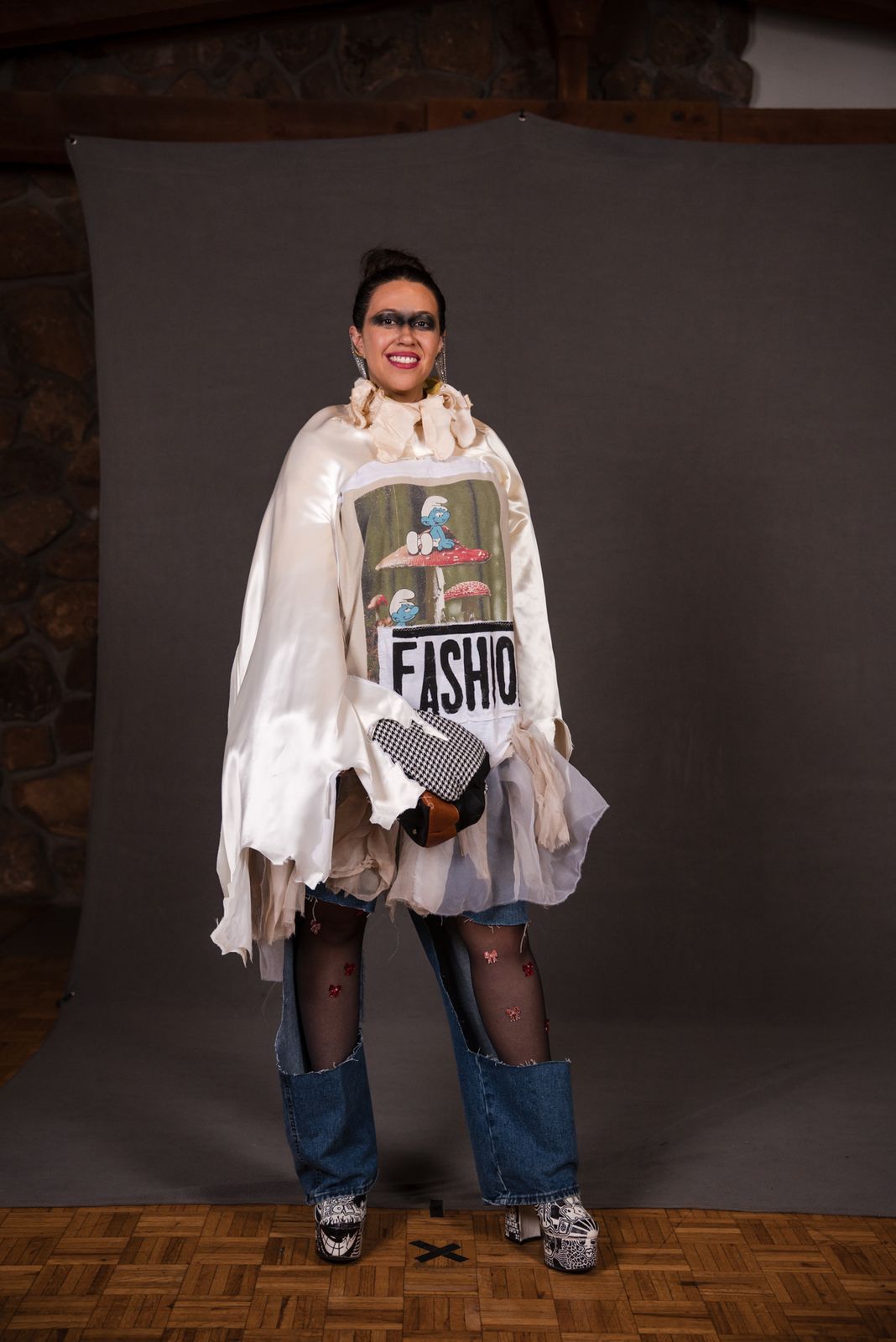 Model in a white poncho printed with a fish