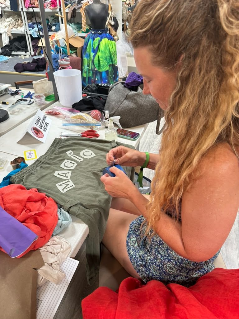 Designer smiling at her sewing table