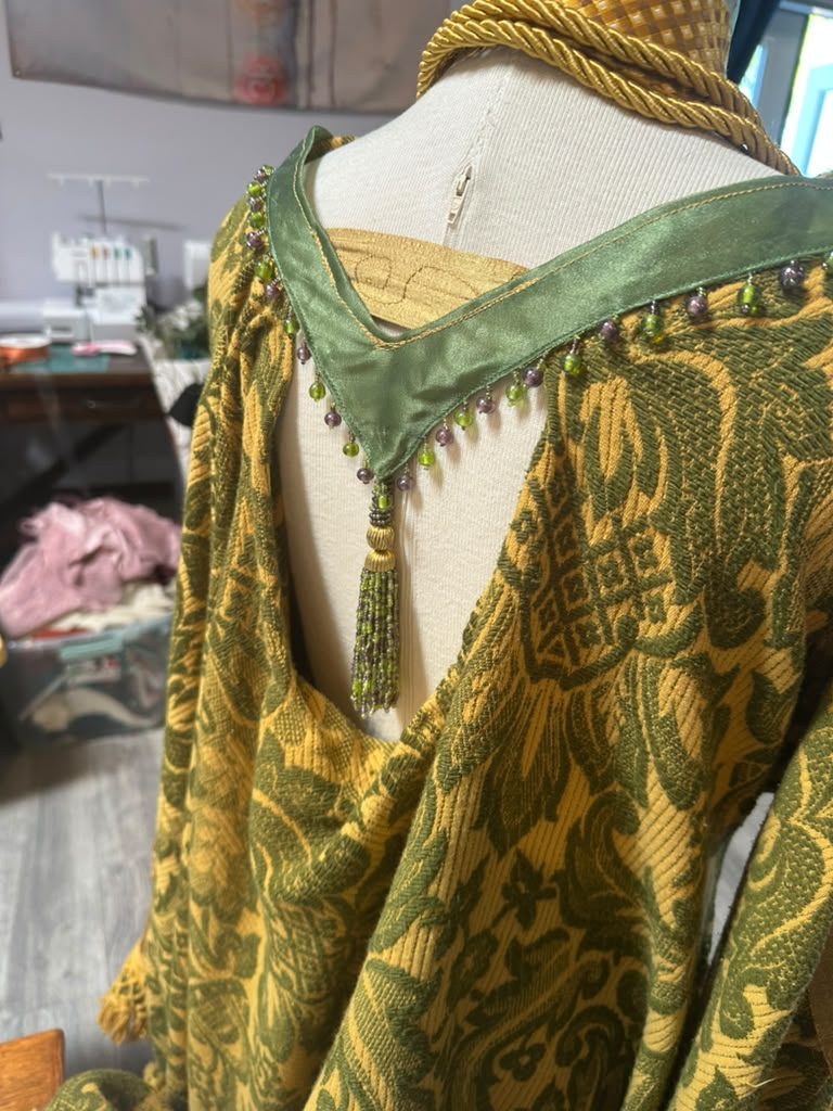 Green beaded trim on a gold brocade top