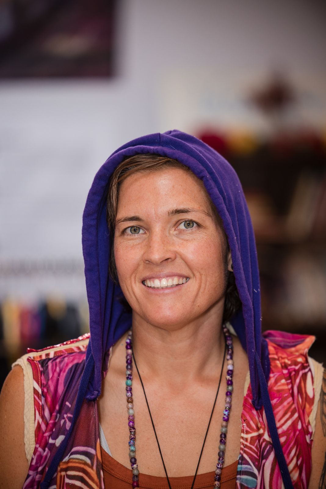 Designer in a purple hood and paisley top