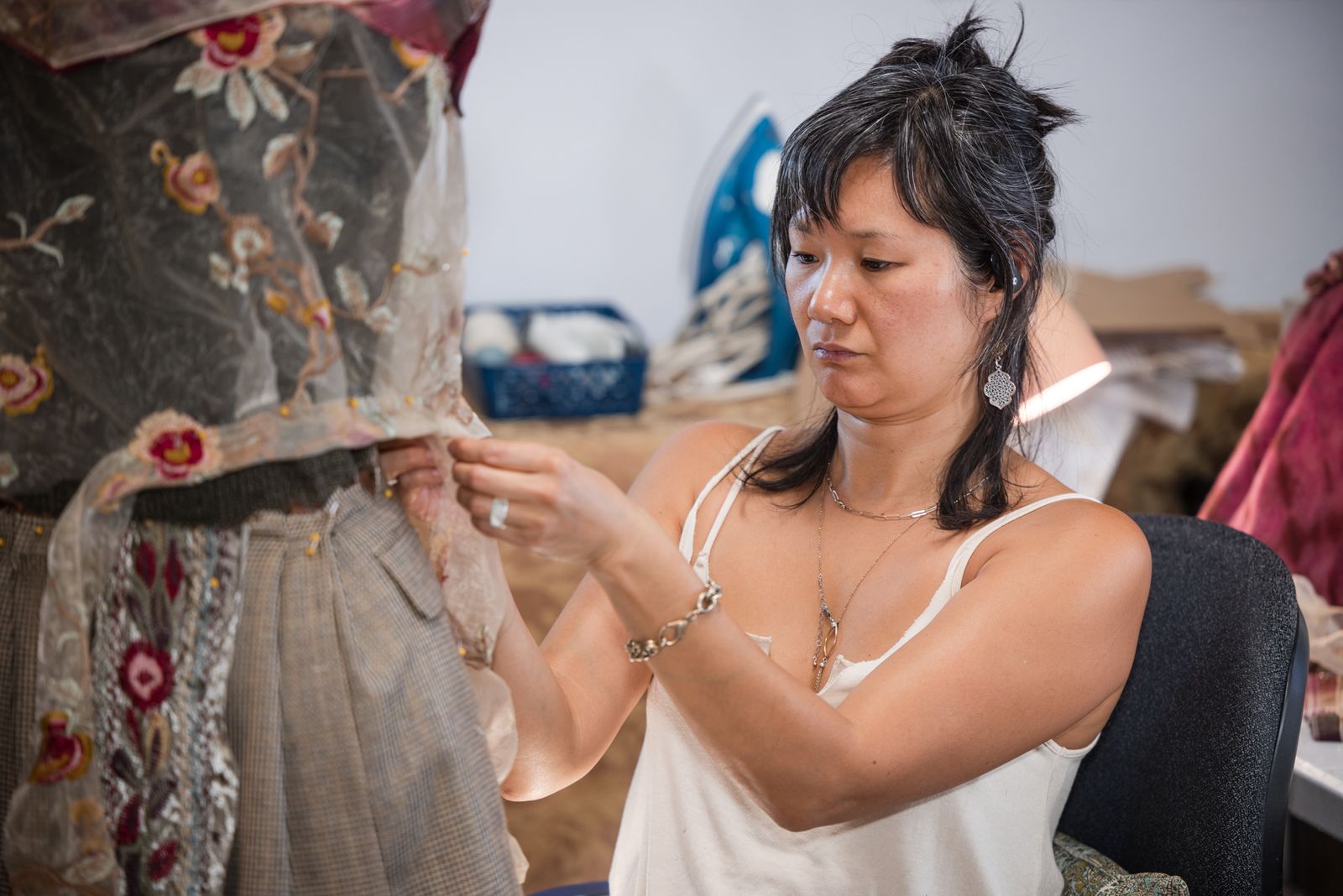 Designer hand-stitching a floral piece