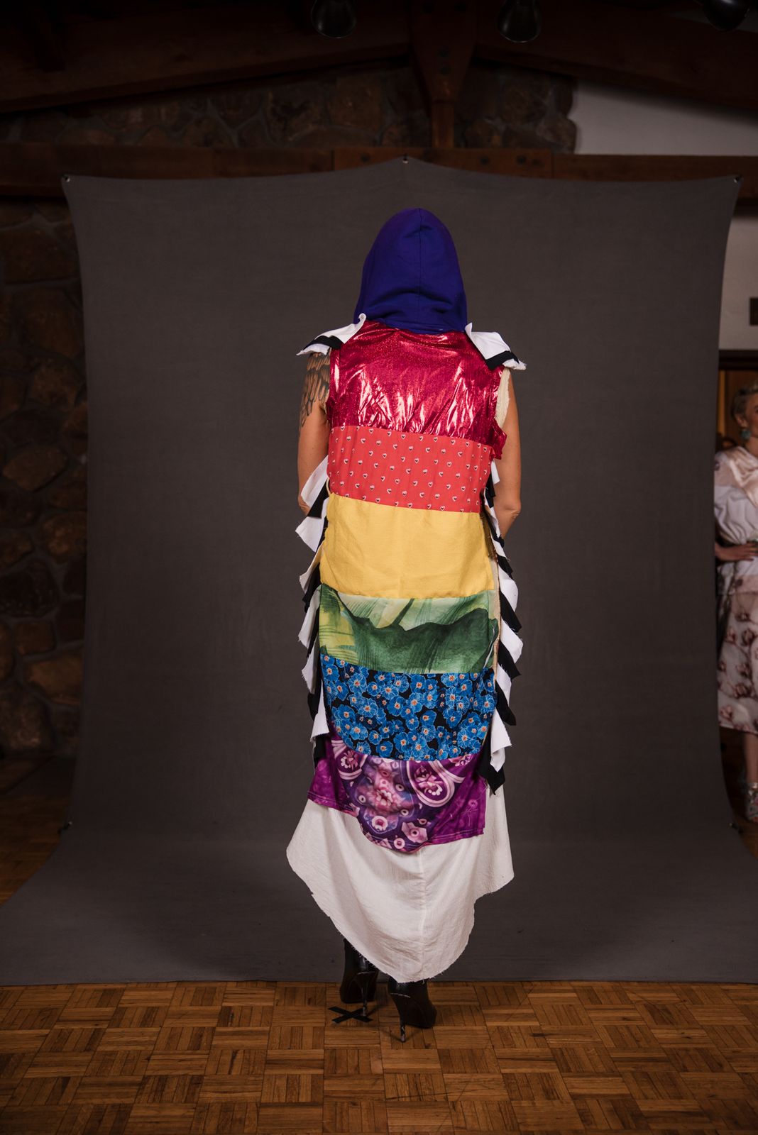 Back of a rainbow hooded cape