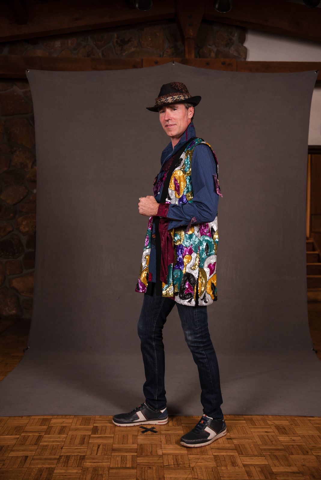 Model in a colorful patchwork jacket and hat